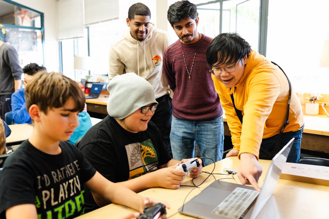 Graduate students in the game design and analysis course at Northeastern’s Oakland campus oversee a playtest session with 4th and 5th graders from the Mills College Children’s School at Northeastern