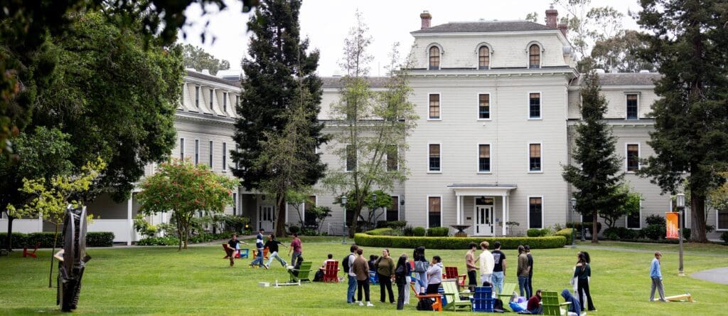 Students gather on lawn behind Mills Hall