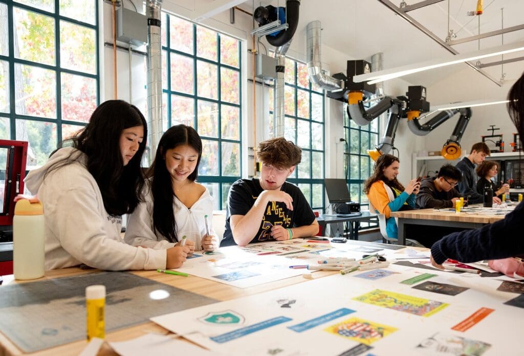 Students work on artboards in the Makerspace at Northeastern University's Oakland campus