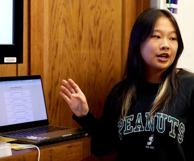 Student with laptop speaking