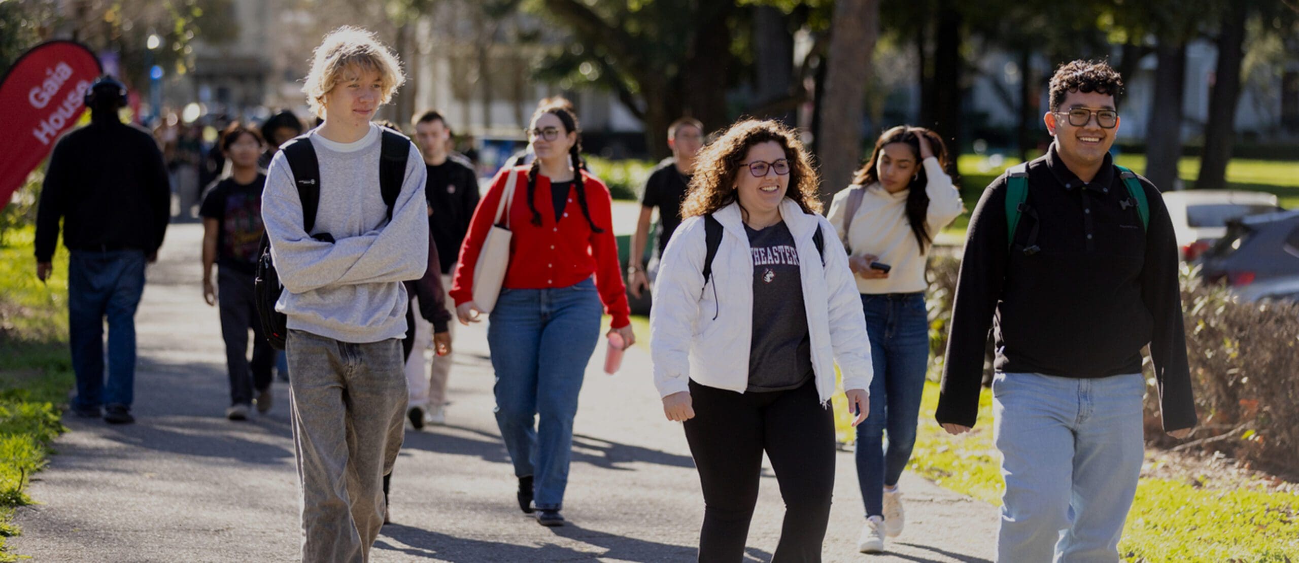 Students walk along path near Mills Hall on the Northeastern University Oakland campus