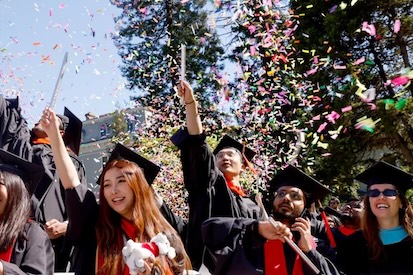 Graduates celebrate at Holmgren Meadow on the Oakland campus. Photo by Scott Chernis for Northeastern University