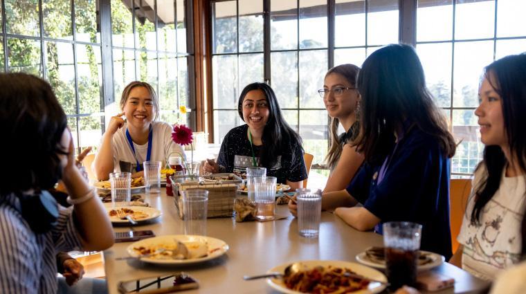 Students dine at table at Founders Common